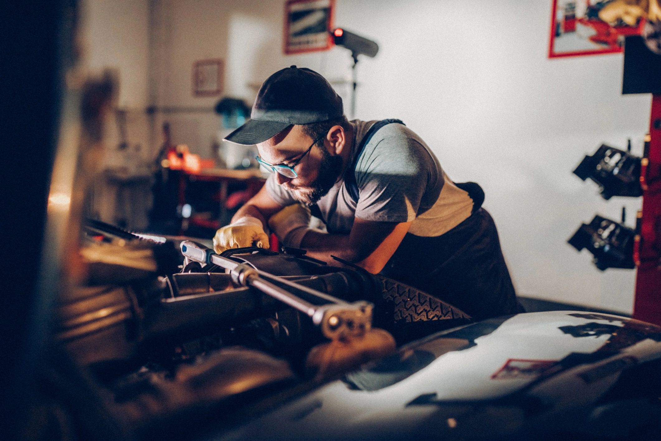 Technician working on a vehicle in a garage
