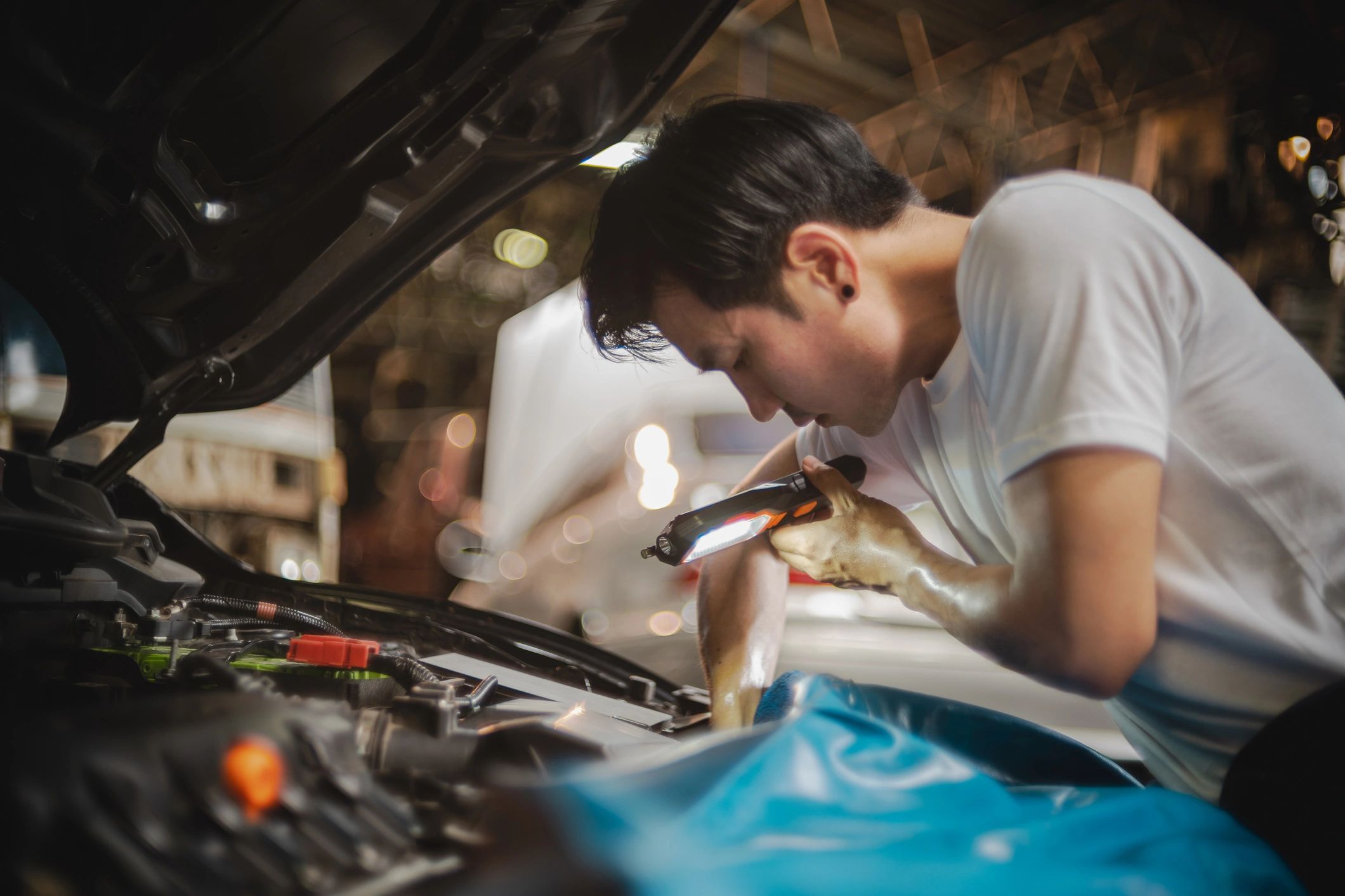 Technician inspecting an engine bay during diagnostics