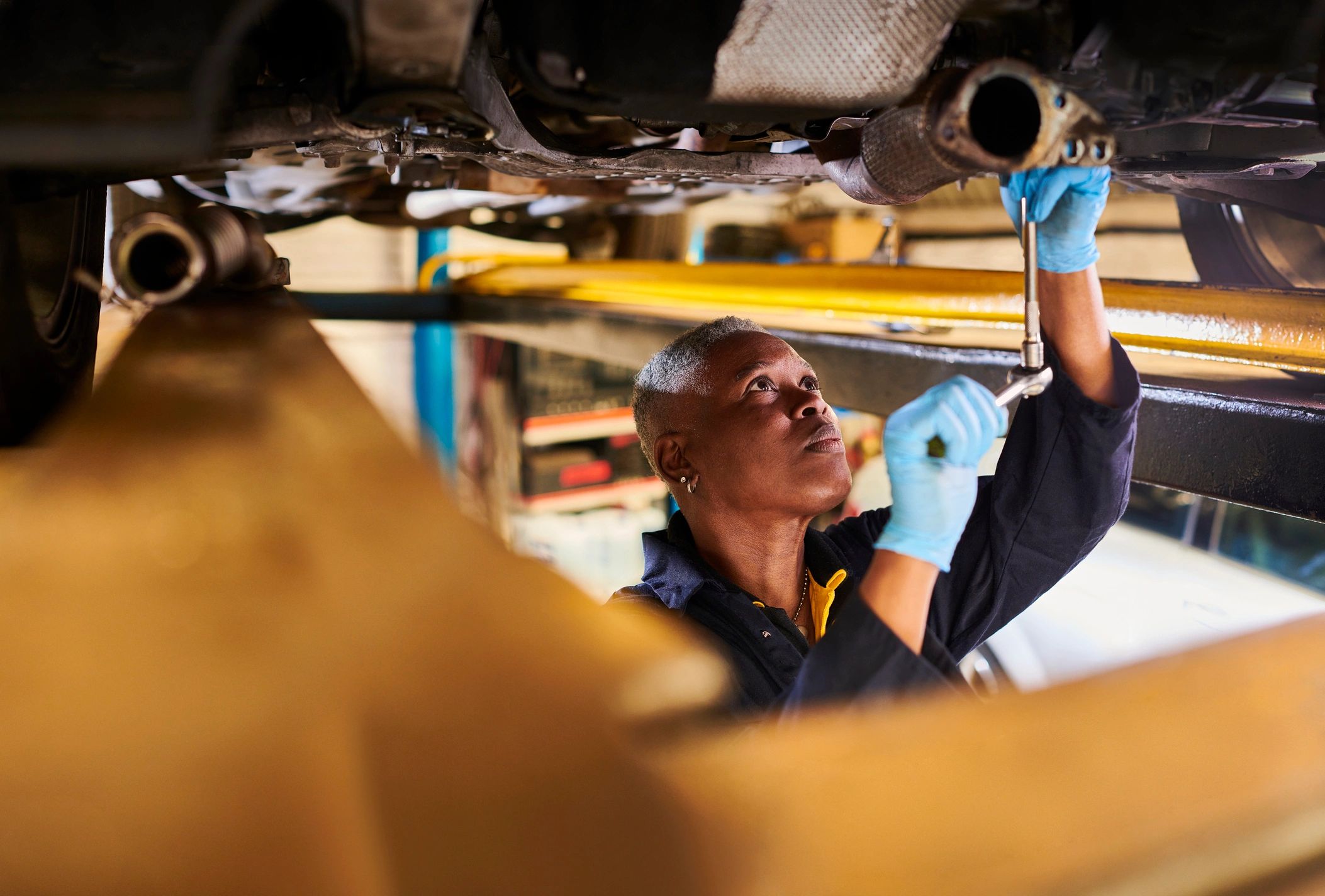 ASE-certified technician inspecting a vehicle