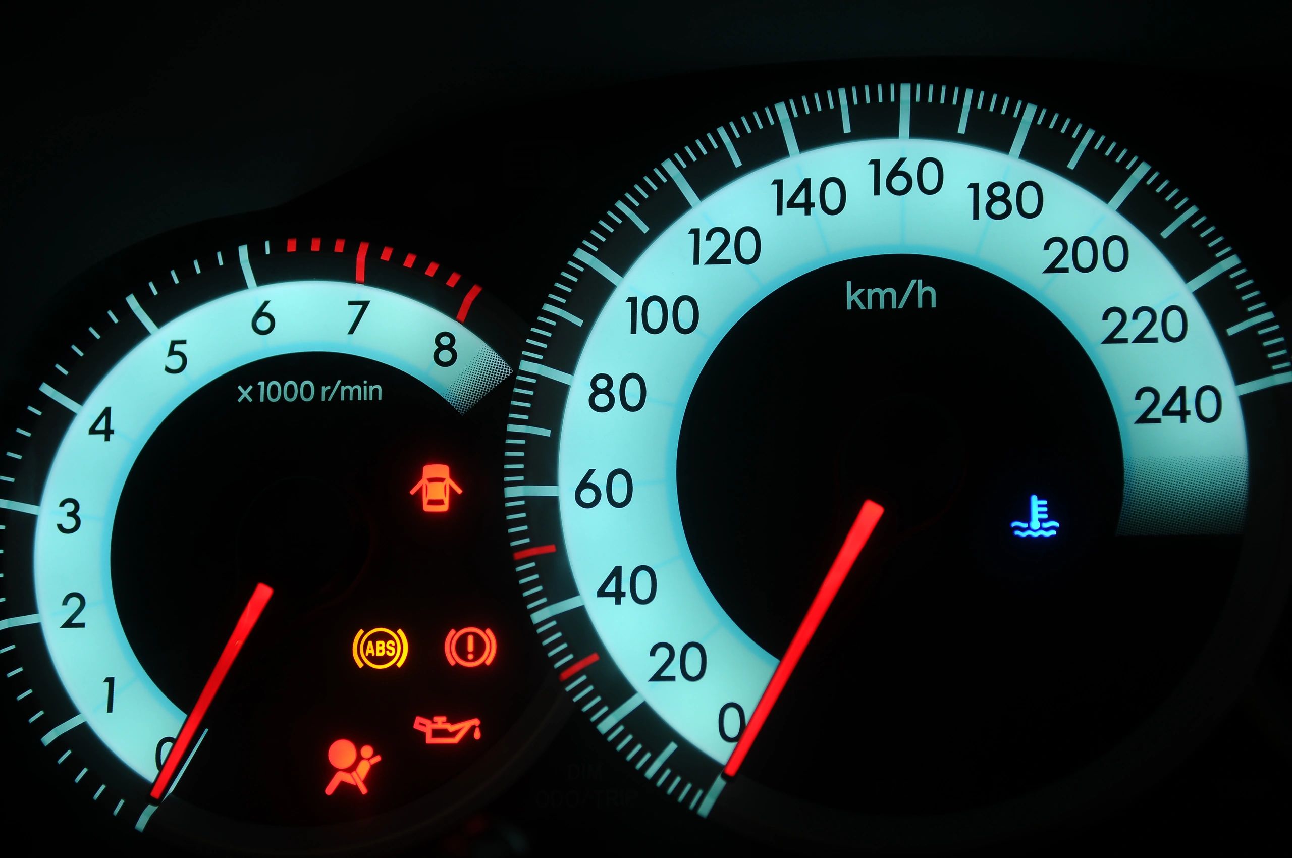 Close-up of a car dashboard with illuminated warning lights