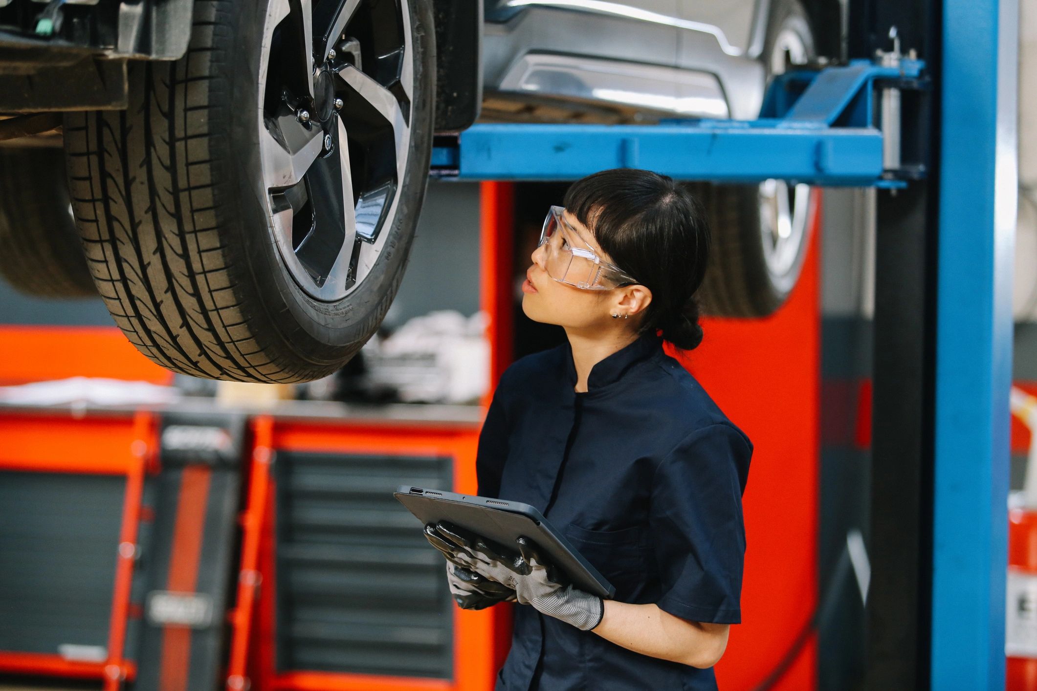 Technician in a repair shop with a tablet