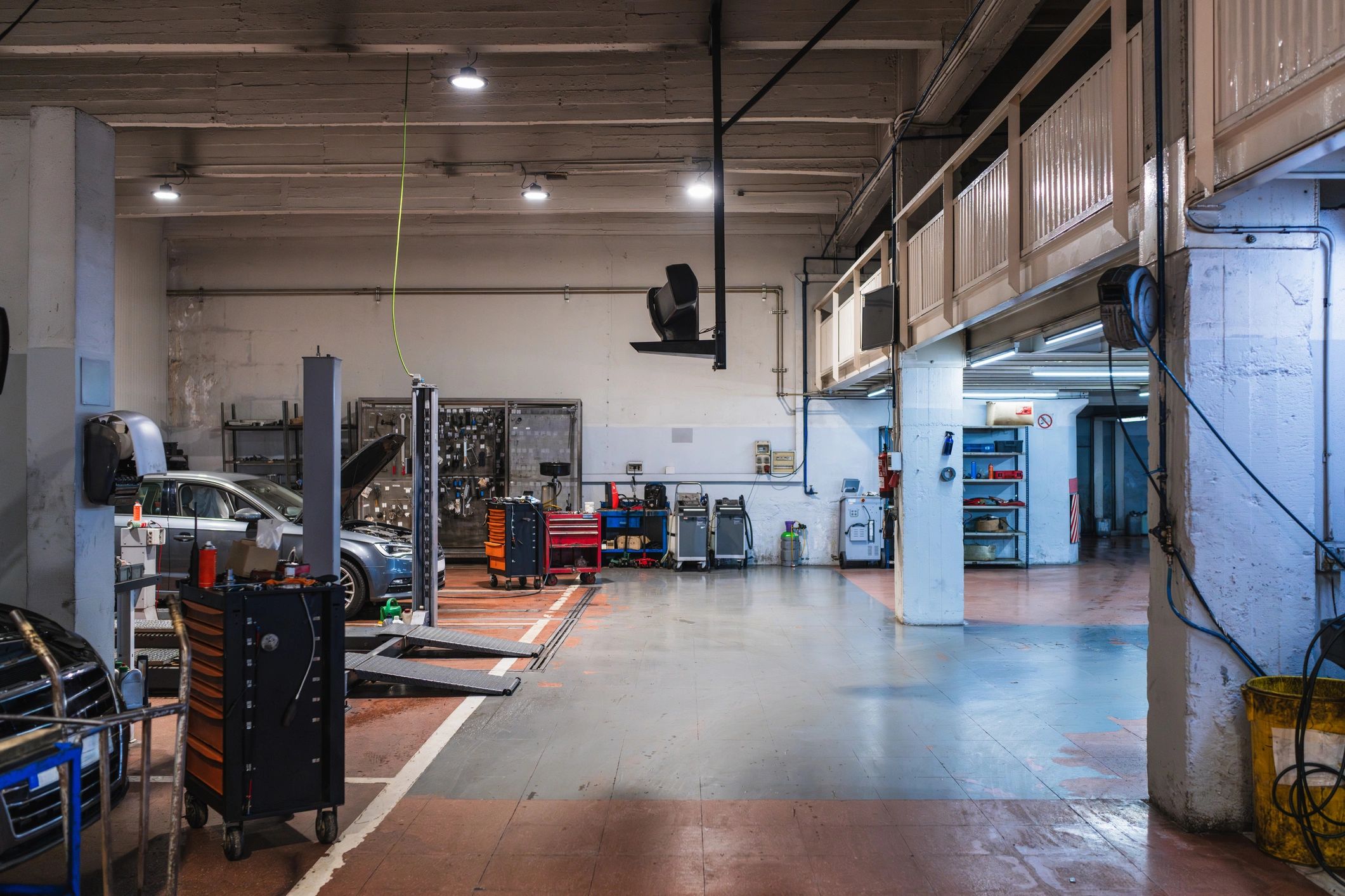 Auto repair shop service bays with lifts and toolboxes