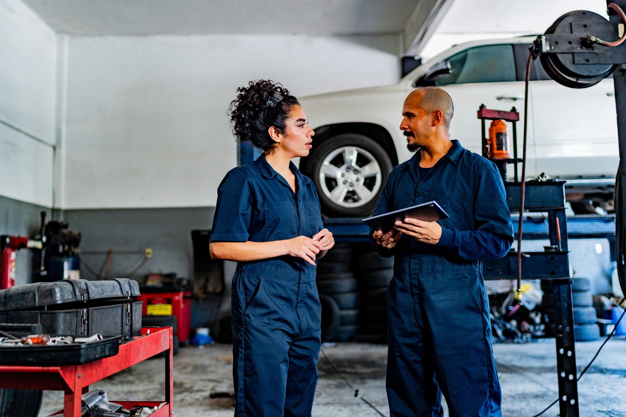 Mechanics talking at auto repair shop