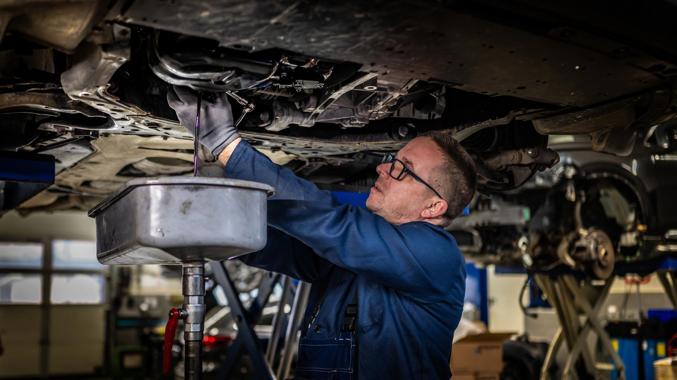 Technician changing engine oil during routine service