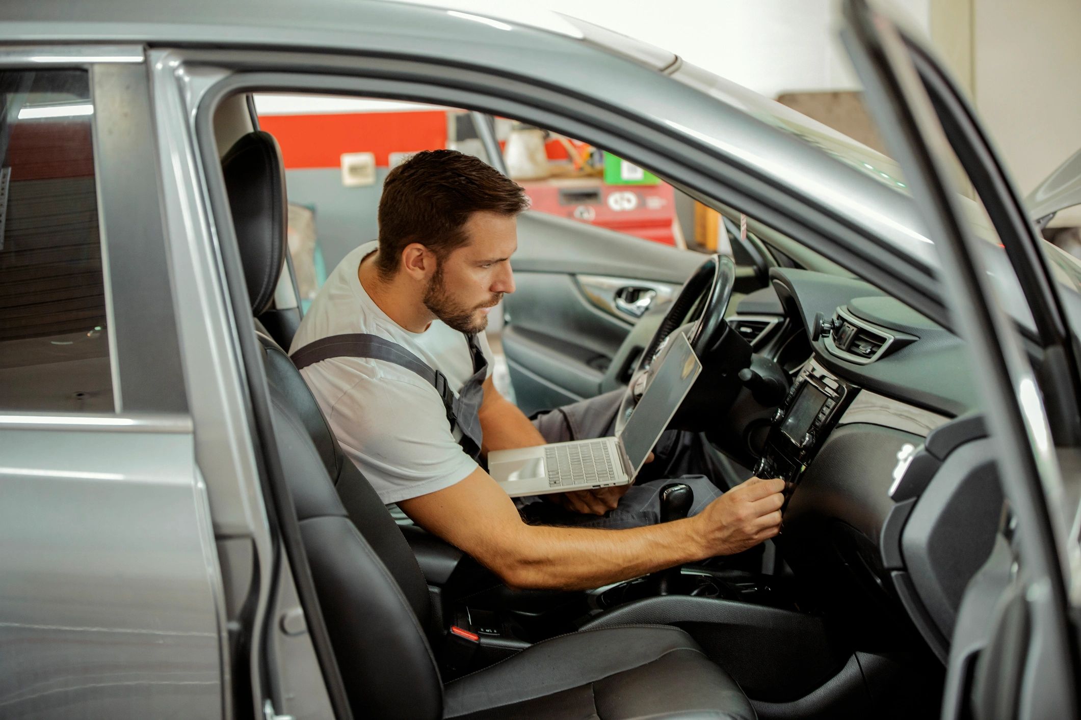 Mechanic using a laptop to run vehicle diagnostics
