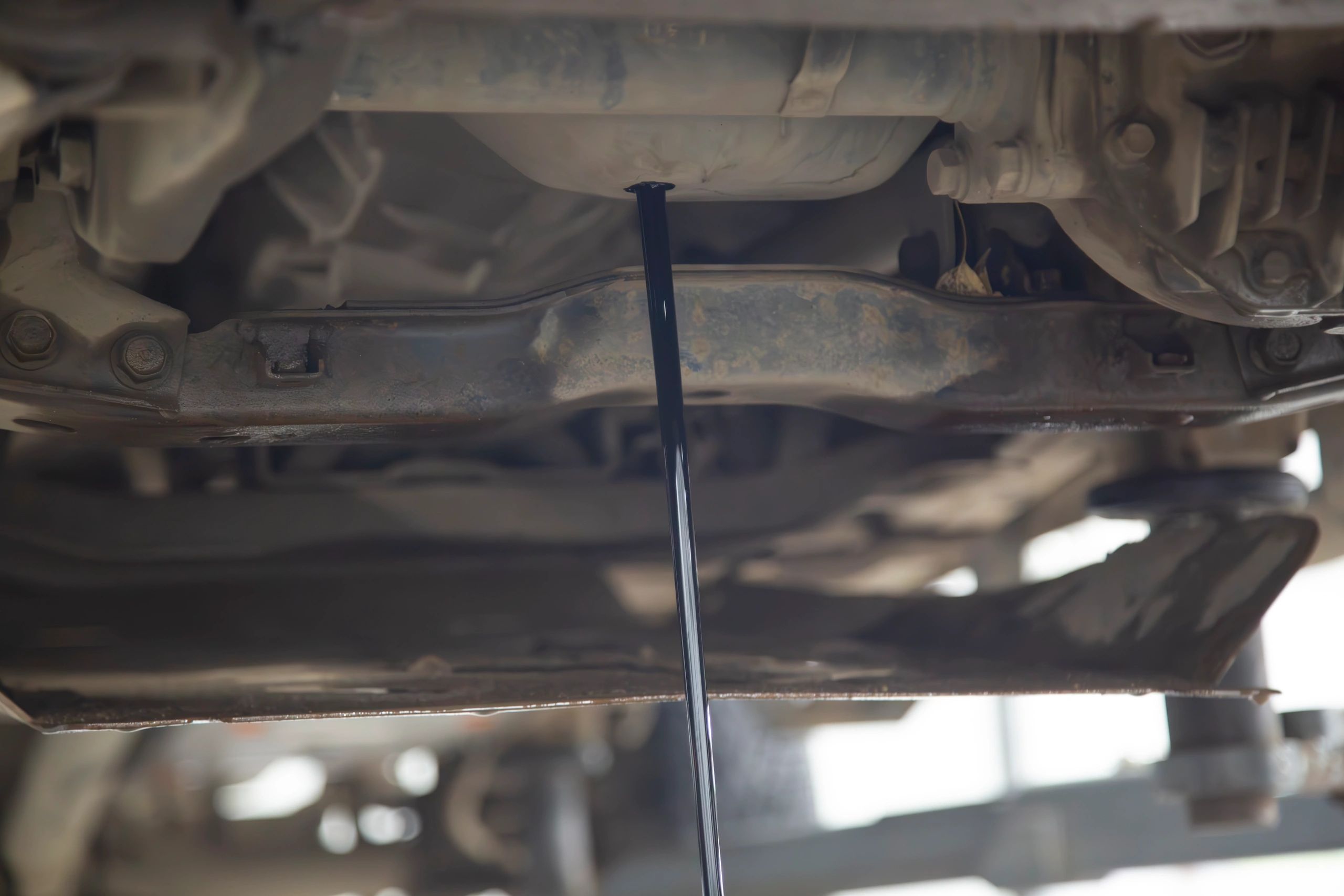 Close-up of vehicle fluid service in progress